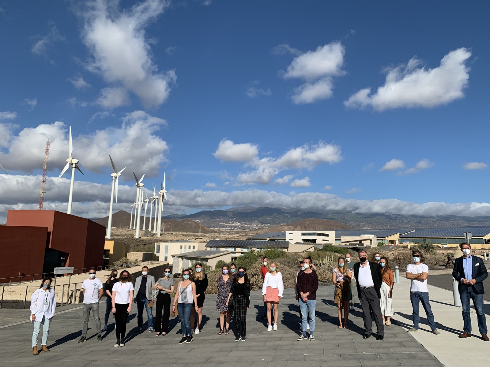 CIB 2021 full group with masks at ITER wind turbines