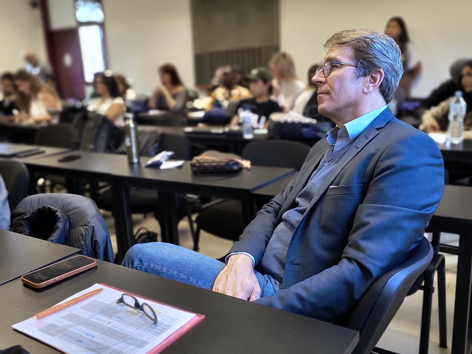 Prof. Dr. Andreas Müller listening in a session, 2025